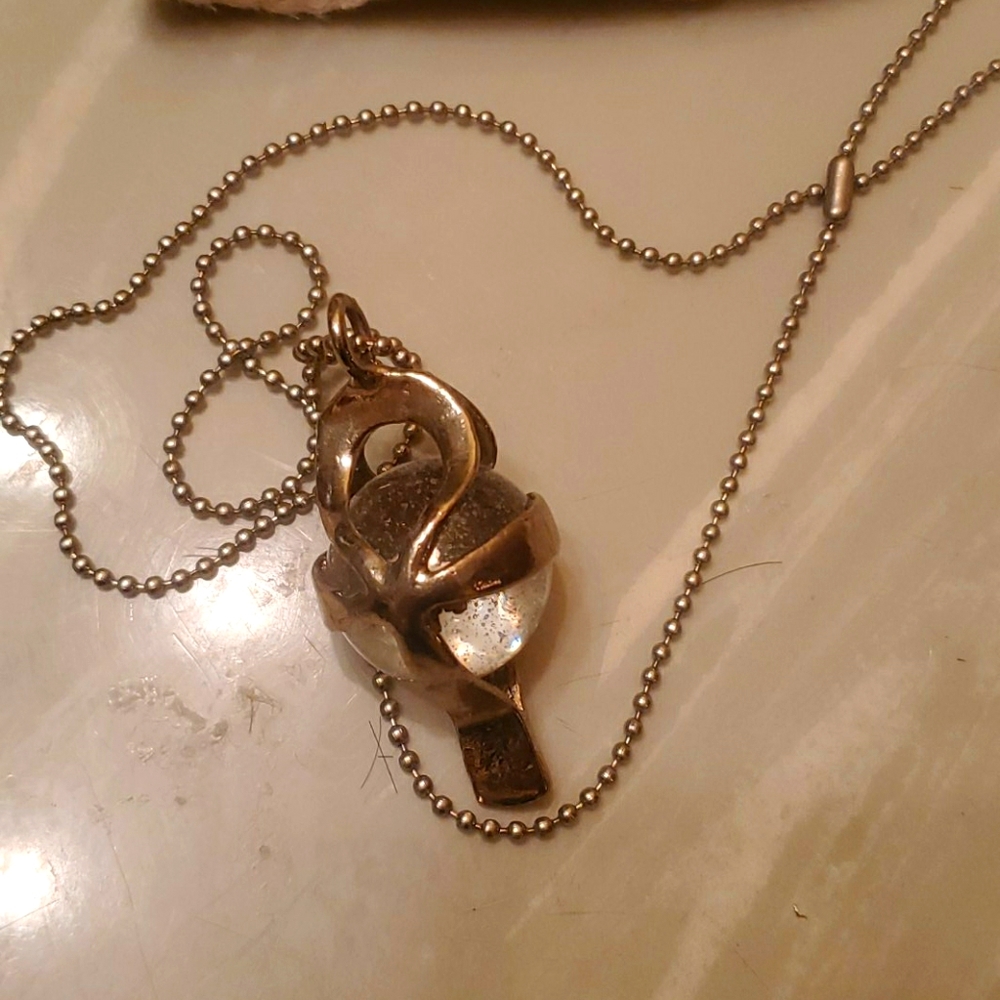 Necklace with cross charm with crystal ball inside